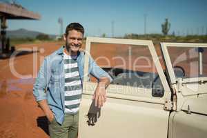 Man standing with arms crossed near his car