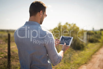 Man using digital tablet on a sunny day