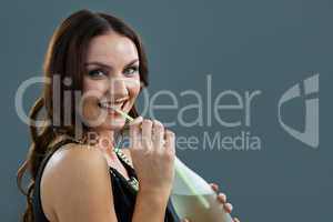 Woman drinking champagne with straw