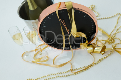 Champagne with clock and glass on white background