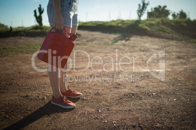 Woman holding a petrol can