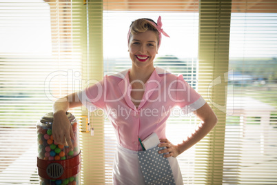 Waitress standing with hand on hip in restaurant