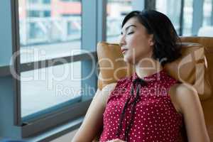 Female executive sleeping in futuristic office