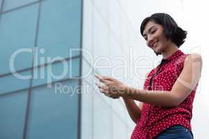 Female executive using glass sheet