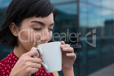 Female executive having coffee