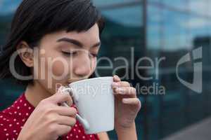 Female executive having coffee