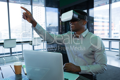 Male executive using virtual reality headset Male executive using virtual reality headset