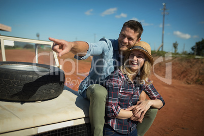 Couple embracing each other on a car