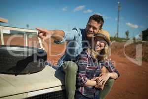 Couple embracing each other on a car