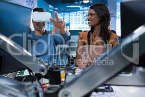 Executives using virtual reality headset at desk