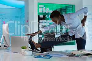 Female executive performing exercise at desk