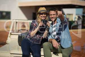 Couple sitting together on a car