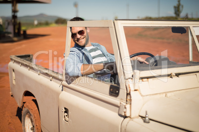 Man relaxing in a car on a sunny day