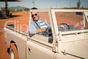 Man relaxing in a car on a sunny day