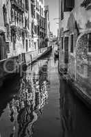 Canals and historic buildings of Venice, Italy, black and white.