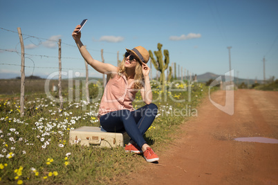 Woman taking selfie with mobile phone