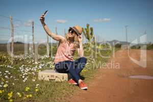 Woman taking selfie with mobile phone