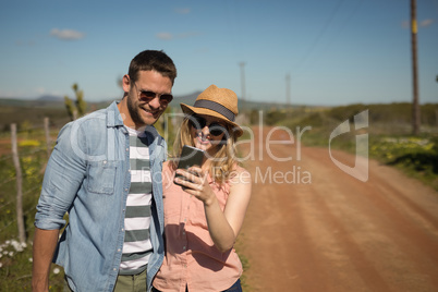 Couple looking at photos on mobile phone