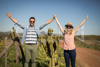 Couple standing together near a plant