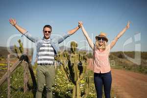 Couple standing together near a plant