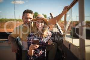 Couple using mobile phone in a car