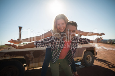 Man giving a piggyback ride to woman