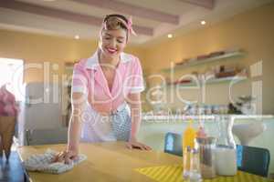 Waitress cleaning the table in restaurant