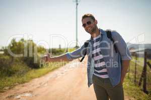 Man hitchhiking on a sunny day