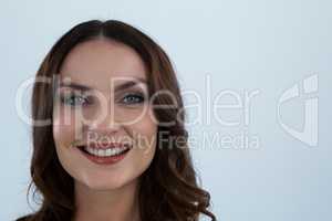 Smiling woman looking at camera against white background
