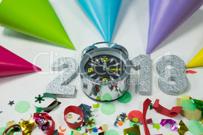 New year 2018 with alarm clock, decoration and party hat