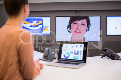 Female executive having video call in boardroom