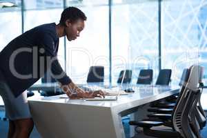 Female executive using laptop at table