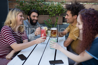 Friends toasting glass of drinks in bar