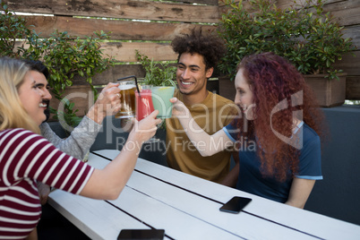 Friends toasting glass of drinks in bar