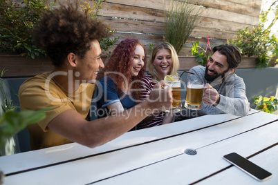 Friends toasting glass of drinks in bar