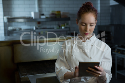 Female chef using digital tablet