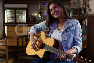 Woman playing guitar