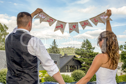 Bride and groom with THANK YOU banner