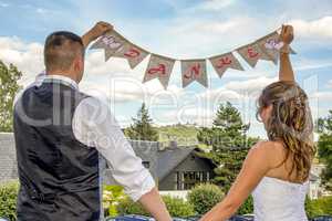 Bride and groom with THANK YOU banner
