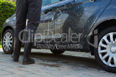 Auto service staff washing a car