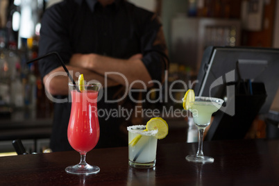 Waiter standing at bar counter