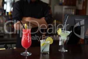 Waiter standing at bar counter