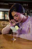 Woman sipping on a drink