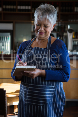 Waitress writing an order in the notepad