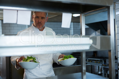 Male chef holding food plate