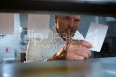 Male chef reading an order