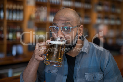 Man having glass of beer in restaurant