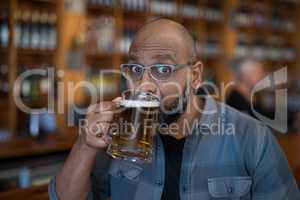 Man having glass of beer in restaurant