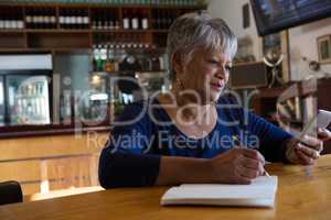 Waitress using her mobilephone