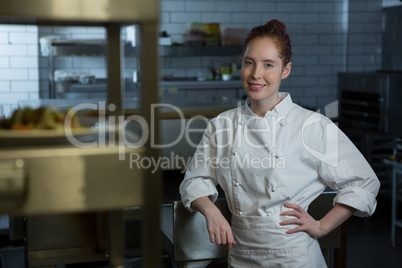 Female chef standing in the kitchen